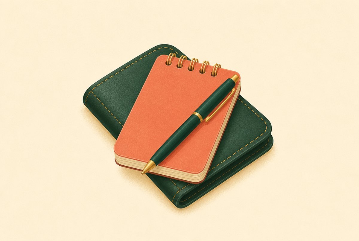 Free Daily Expense Tracker Printable and 30-Day Plan Orange spiral notepad atop a dark green leather notebook with a gold-trimmed pen resting diagonally across both pieces.