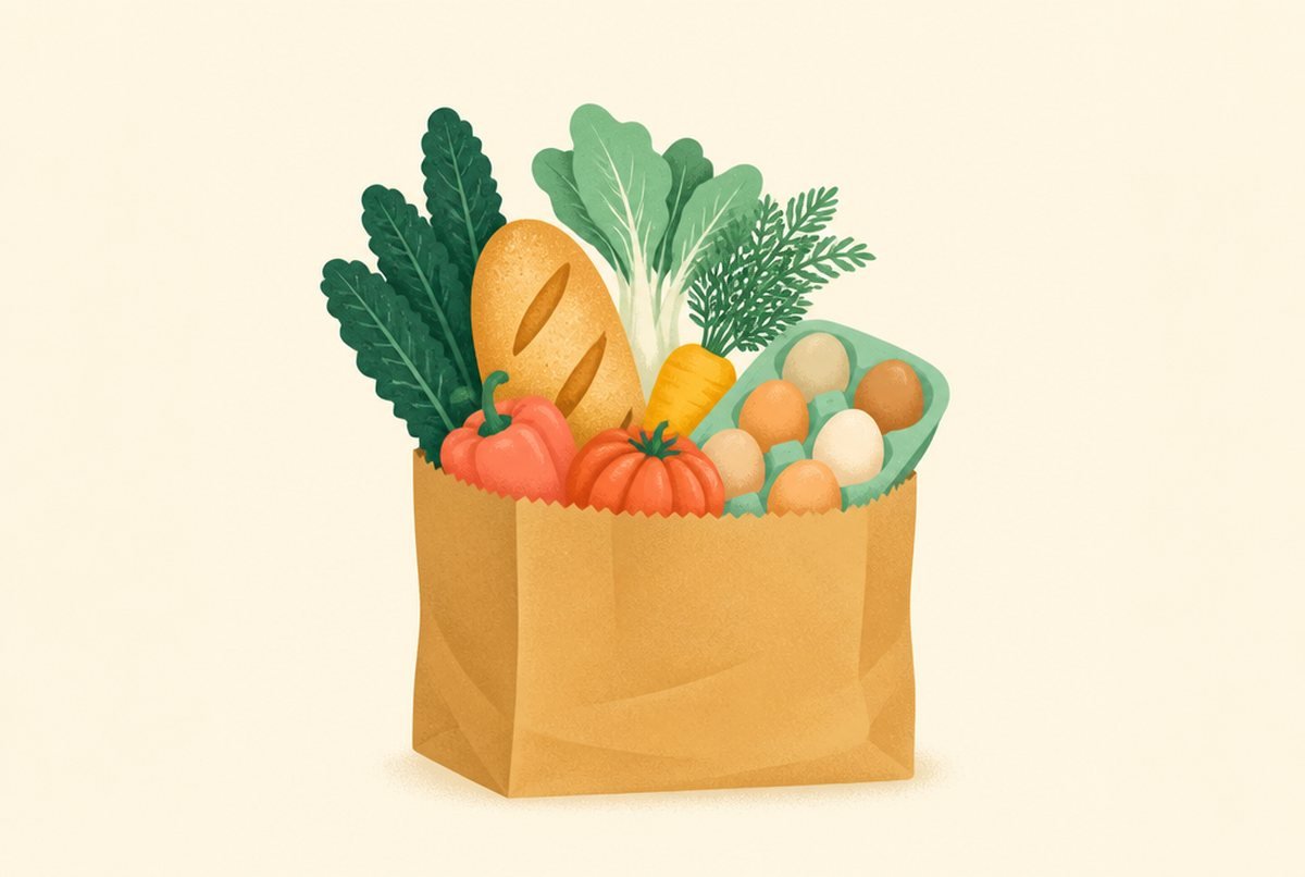 Brown paper grocery bag filled with fresh vegetables and eggs.